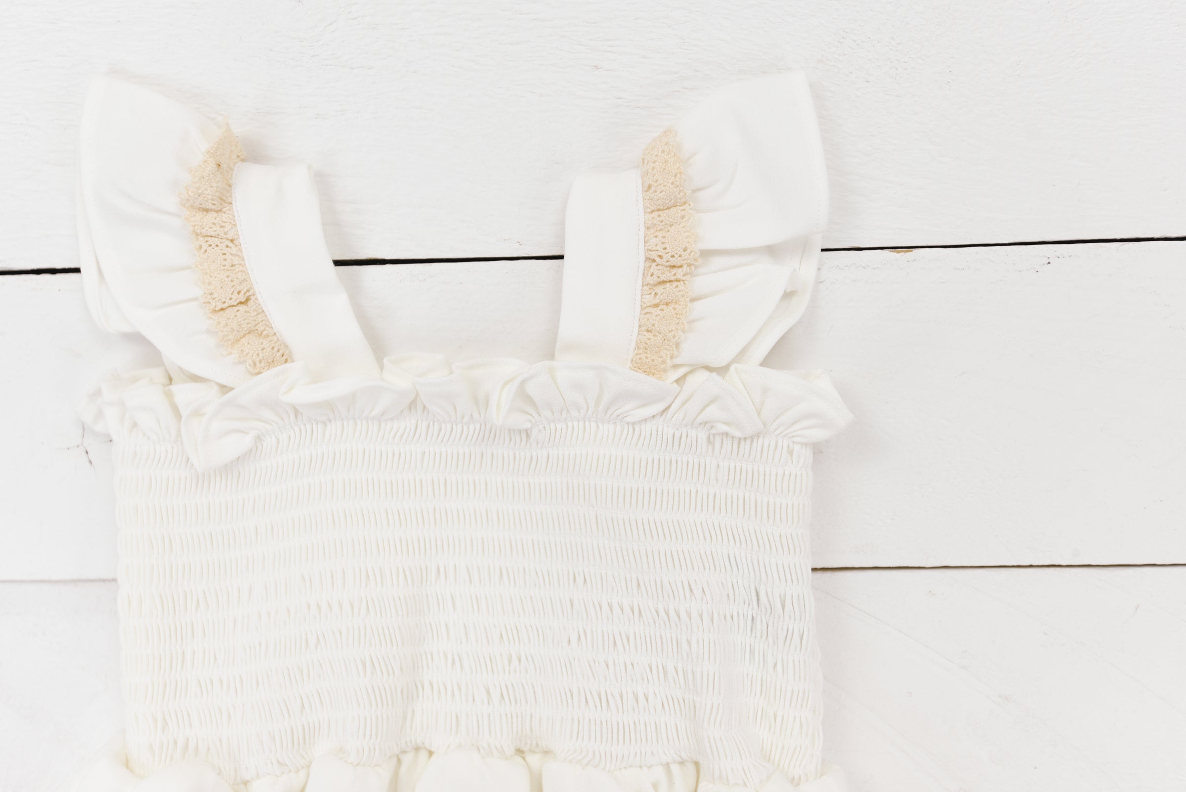 a white dress hanging on a white wall