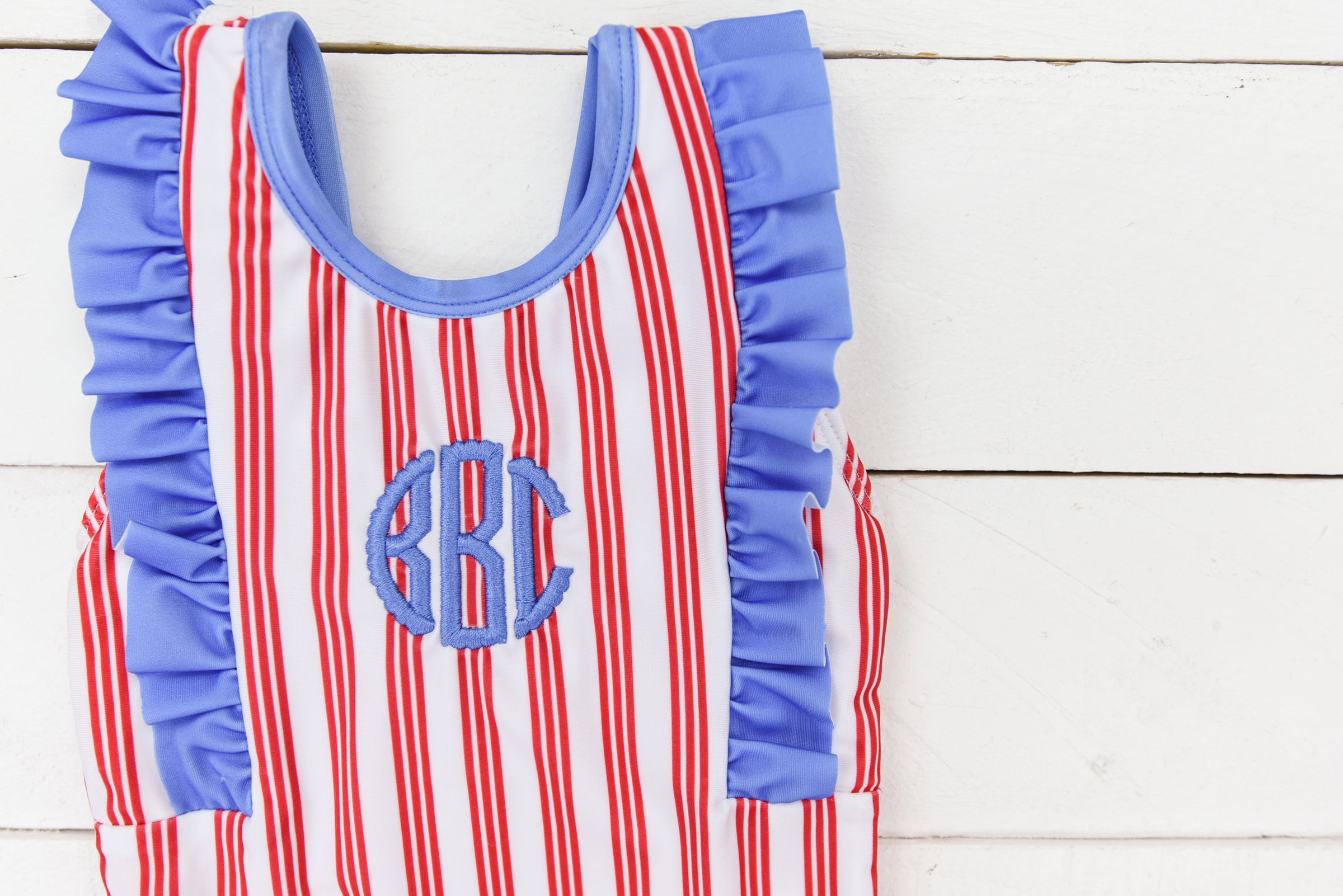 a red, white and blue striped dress hanging on a wall