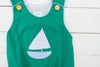 a green shirt with a sailboat on it