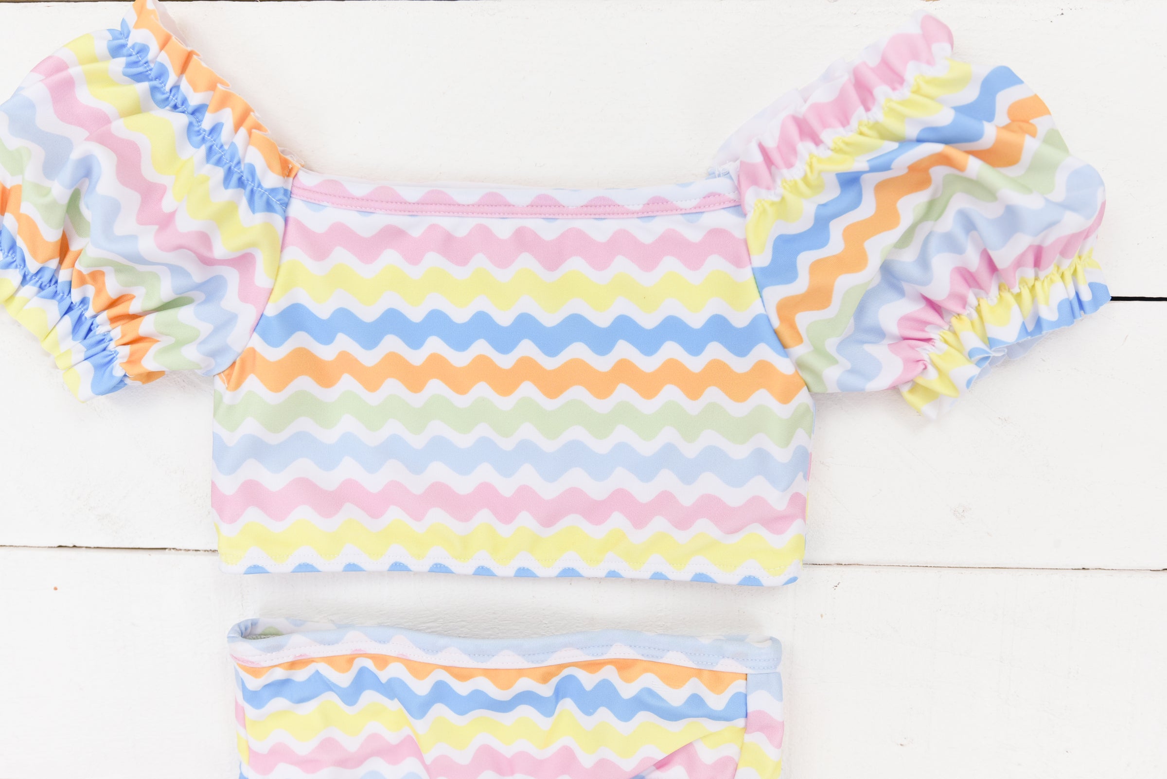 a baby girl's colorful outfit with ruffle sleeves